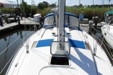 Slide: The Image of 1993 Beneteau Oceanis 370 sailboat docked, showing deck and mast in marina setting. - 6