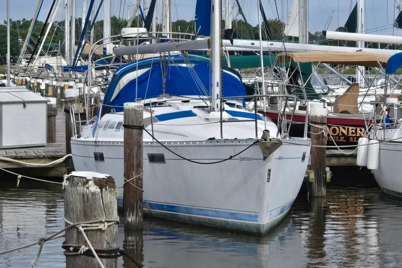 Slide: The Image of 1993 Beneteau Oceanis 370 sailboat docked at a marina, surrounded by other vessels. - 1