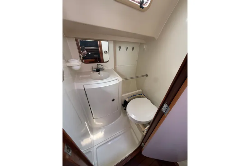 Slide: The Image of Bathroom interior of 1993 Beneteau Oceanis 370 yacht, featuring sink and toilet. - 17
