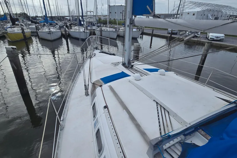 Slide: The Image of Sailboat Beneteau Oceanis 370, 1993 model, docked in a marina with other boats. - 8