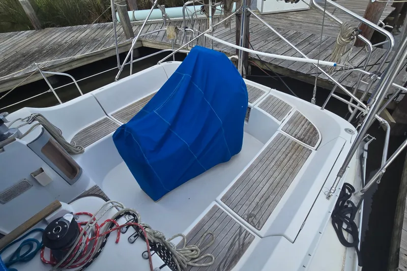 Slide: The Image of Cockpit of 1993 Beneteau Oceanis 370 sailboat with blue cover and wooden deck. - 7