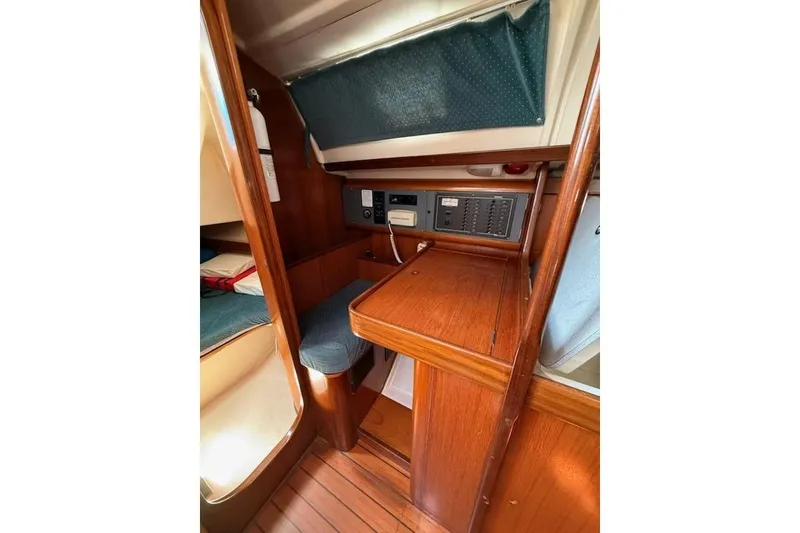 Slide: The Image of Interior of 1993 Beneteau Oceanis 370 sailboat with wooden cabinetry and seating area. - 10