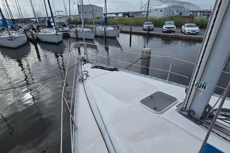 Slide: The Image of 1993 Beneteau Oceanis 370 sailboat docked in marina, surrounded by other boats. - 5