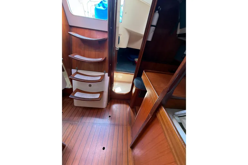 Slide: The Image of Interior of 1993 Beneteau Oceanis 370 sailboat with wooden steps and flooring. - 18