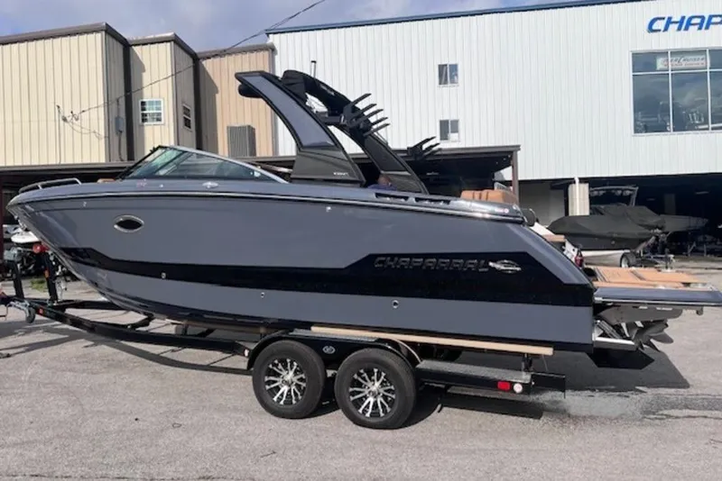 Slide: The Image of 2025 Chaparral 2870 SSX boat on trailer, parked outside a building. - 3