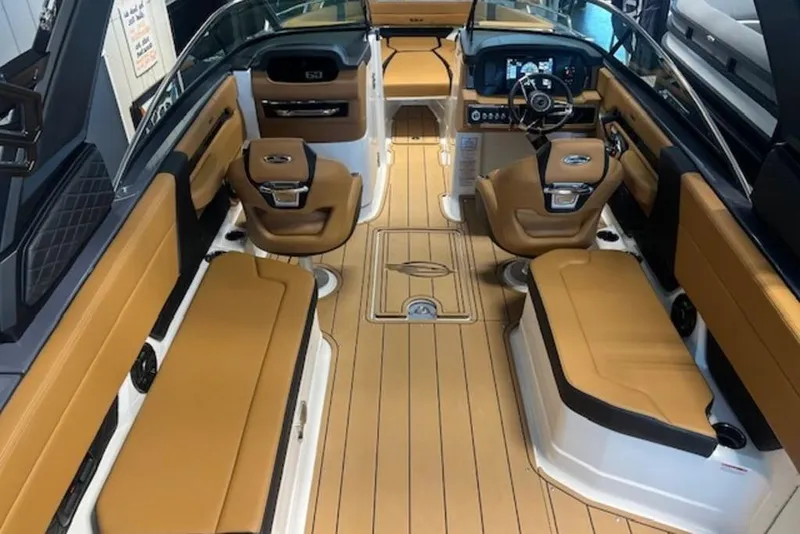 Slide: The Image of Interior of 2025 Chaparral 2870 SSX boat with tan seating and modern dashboard. - 10