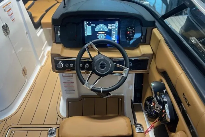 Slide: The Image of 2025 Chaparral 2870 SSX boat cockpit with modern steering and digital dashboard. - 9