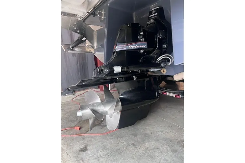 Slide: The Image of 2025 Chaparral 2870 SSX boat with MerCruiser outdrive and dual propellers in a garage setting. - 6