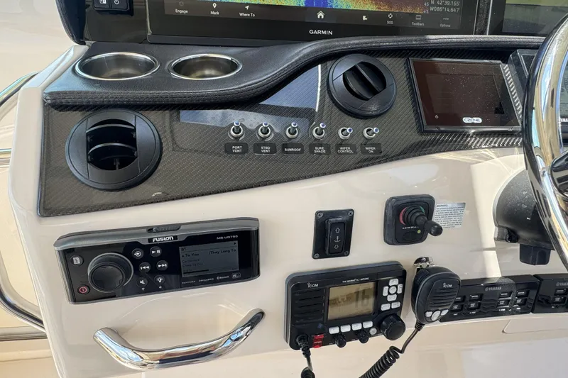 Slide: The Image of Control panel of a 2019 Grady-White Canyon 456 boat with navigation and audio systems. - 27