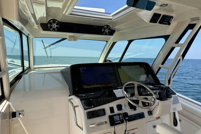 Slide: The Image of Interior view of 2019 Grady-White Canyon 456 boat cockpit with ocean backdrop. - 23