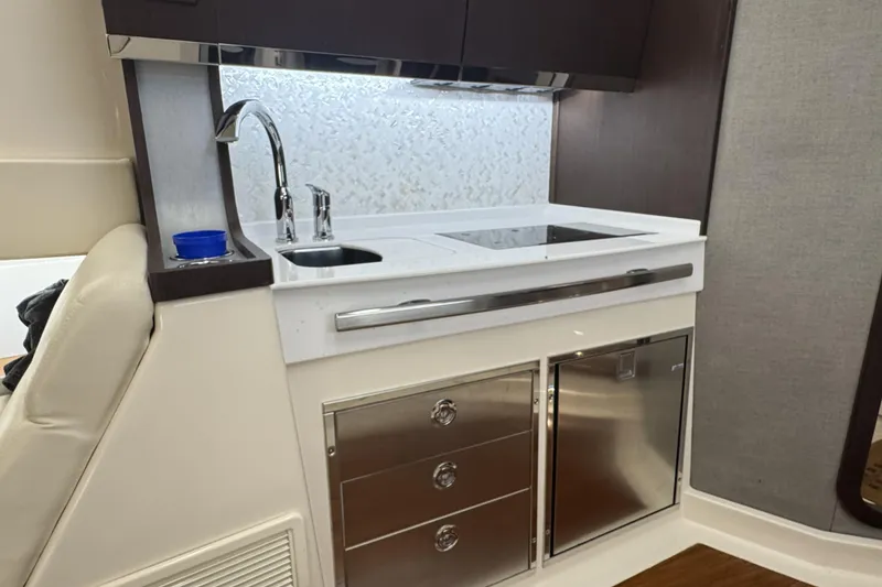 Slide: The Image of 2019 Grady-White Canyon 456 boat interior with modern kitchenette and stainless steel fixtures. - 39