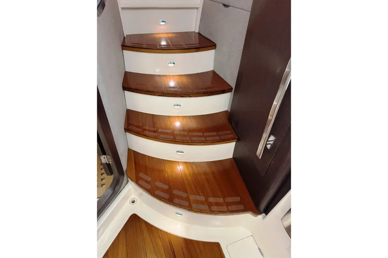 Slide: The Image of Wooden steps with lighting on a 2019 Grady-White Canyon 456 boat interior. - 41
