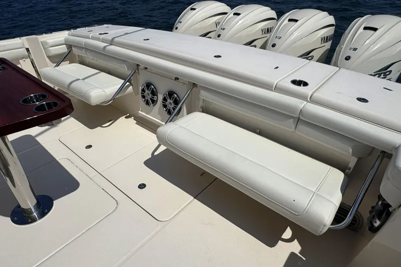 Slide: The Image of 2019 Grady-White Canyon 456 boat interior with seating and Yamaha V8 engines. - 13