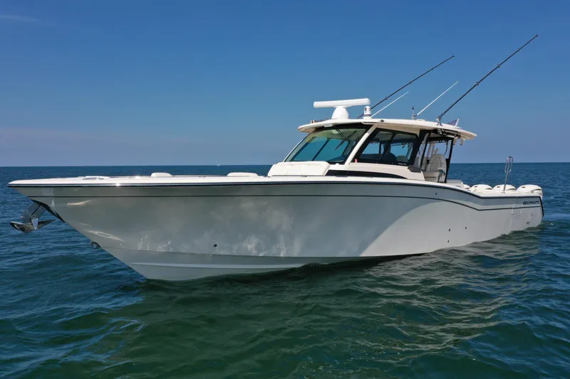 Slide: The Image of 2019 Grady-White Canyon 456 boat on open water under clear blue sky. - 2