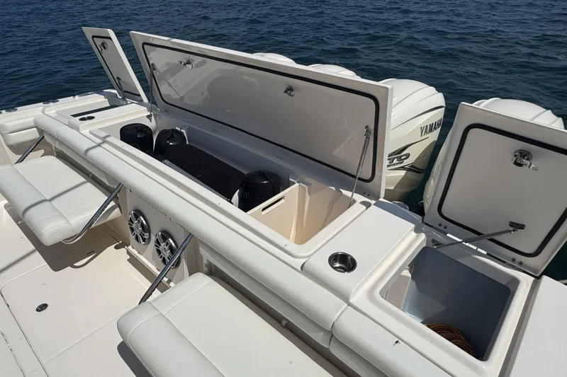 Slide: The Image of 2019 Grady-White Canyon 456 boat with open storage compartments and Yamaha engines. - 14