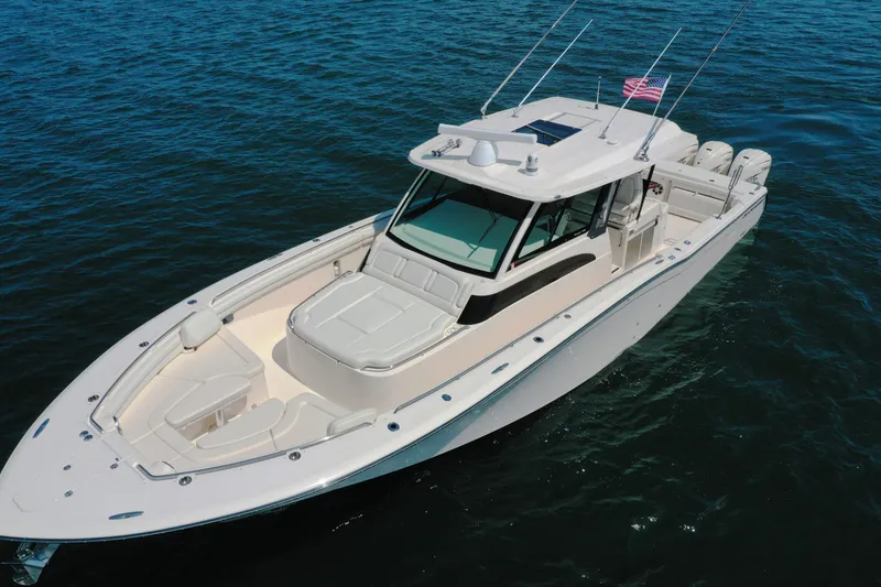 Slide: The Image of 2019 Grady-White Canyon 456 boat on open water, showcasing sleek design and spacious deck. - 7