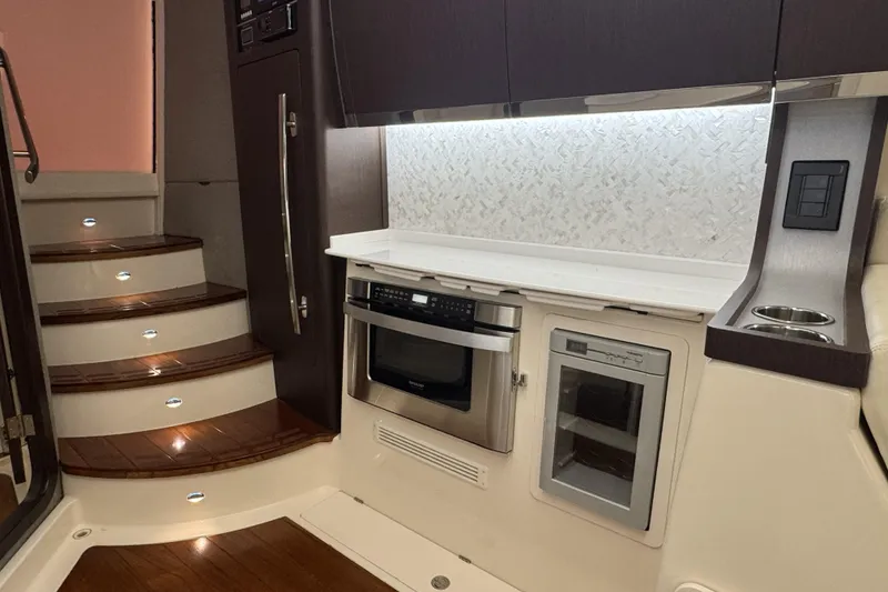 Slide: The Image of Luxurious 2019 Grady-White Canyon 456 yacht interior with modern kitchen and elegant staircase. - 40