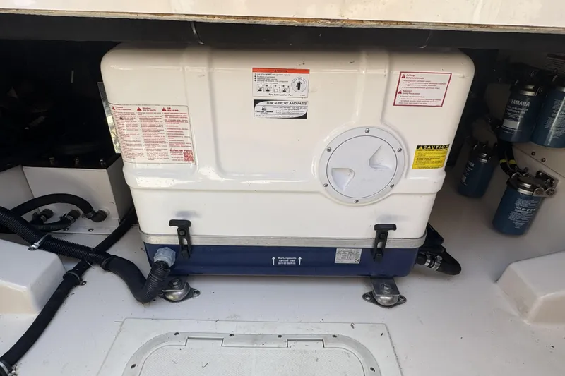 Slide: The Image of 2019 Grady-White Canyon 456 engine compartment with fuel filters and equipment. - 48