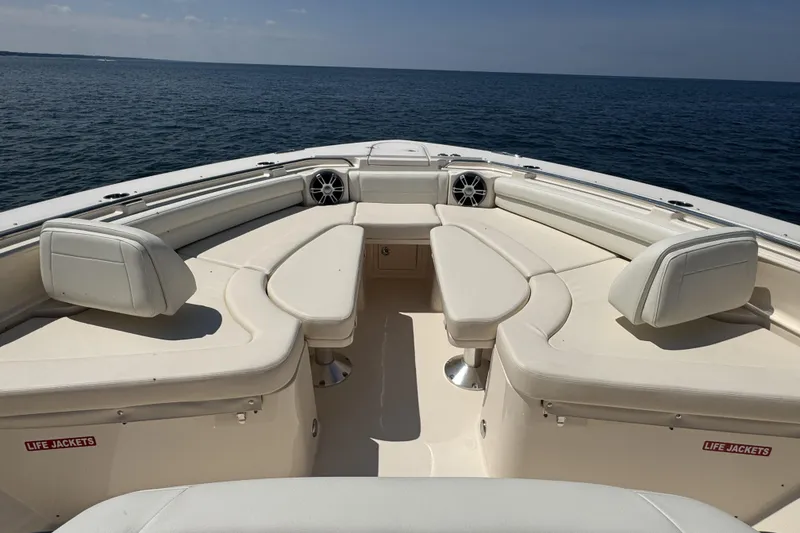 Slide: The Image of 2019 Grady-White Canyon 456 boat interior with spacious seating on open water. - 34