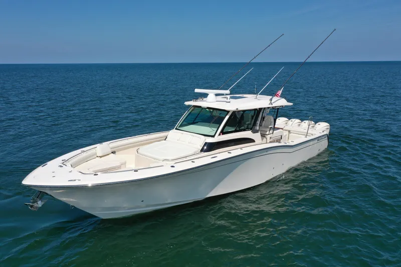 Slide: The Image of 2019 Grady-White Canyon 456 boat on open water, clear sky background. - 4
