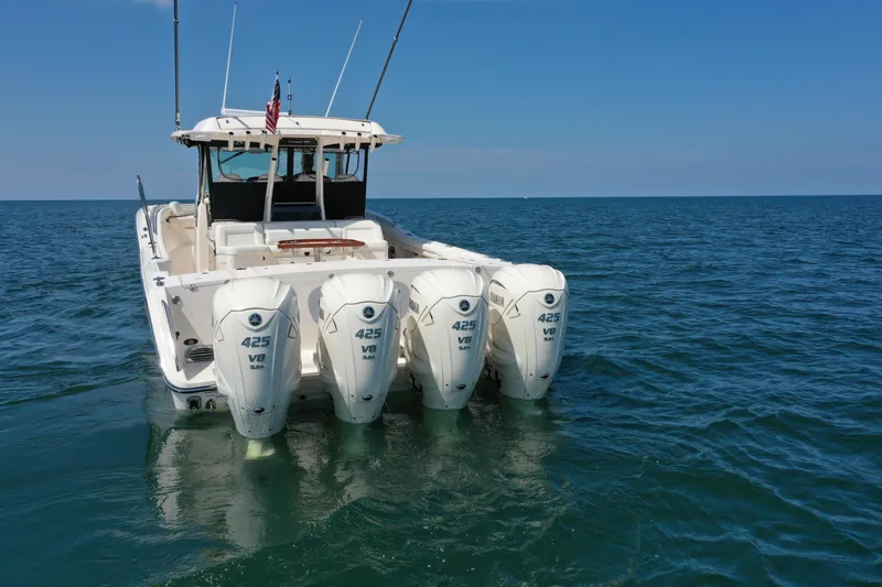 Slide: The Image of 2019 Grady-White Canyon 456 boat with four Yamaha 425 V8 engines on open water. - 9