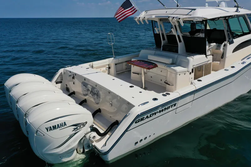 Slide: The Image of 2019 Grady-White Canyon 456 boat with Yamaha engines on open water. - 10