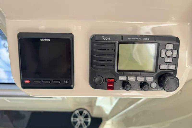 Slide: The Image of Garmin and Icom marine electronics on 2019 Grady-White Canyon 456 boat dashboard. - 31