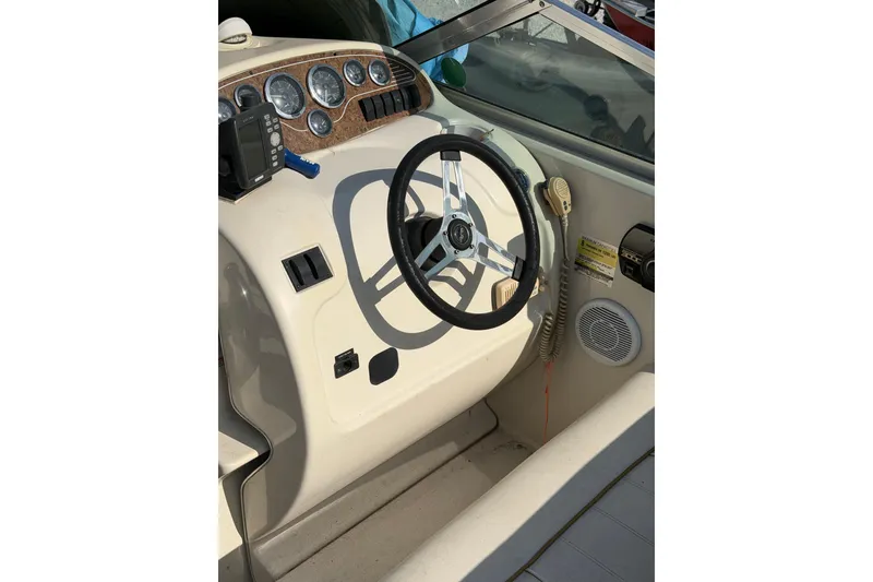 Slide: The Image of Steering console of a 1999 Sea Ray 240 Sundancer boat with gauges and controls. - 6