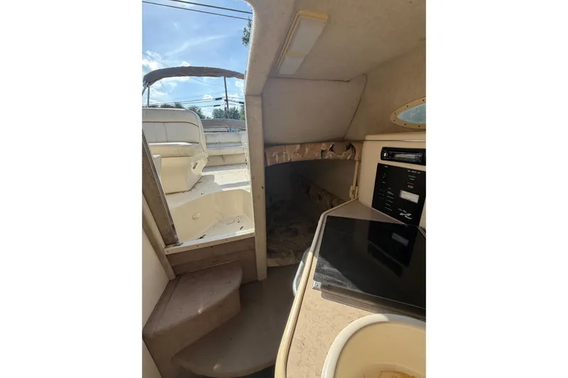 Slide: The Image of Interior view of 1999 Sea Ray 240 Sundancer cabin with kitchenette and seating area. - 15