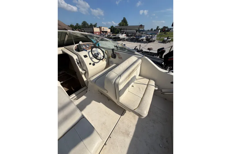 Slide: The Image of 1999 Sea Ray 240 Sundancer boat interior with steering wheel and seating. - 7