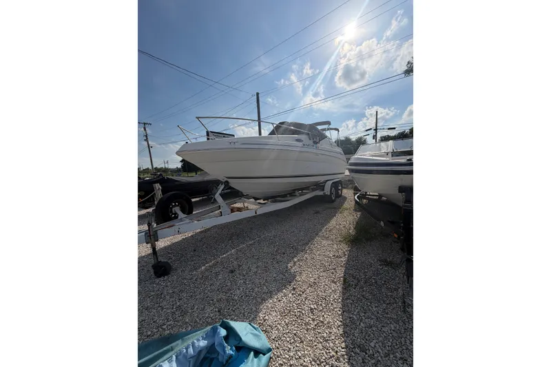 Slide: The Image of 1999 Sea Ray 240 Sundancer boat on trailer under sunny sky. - 1