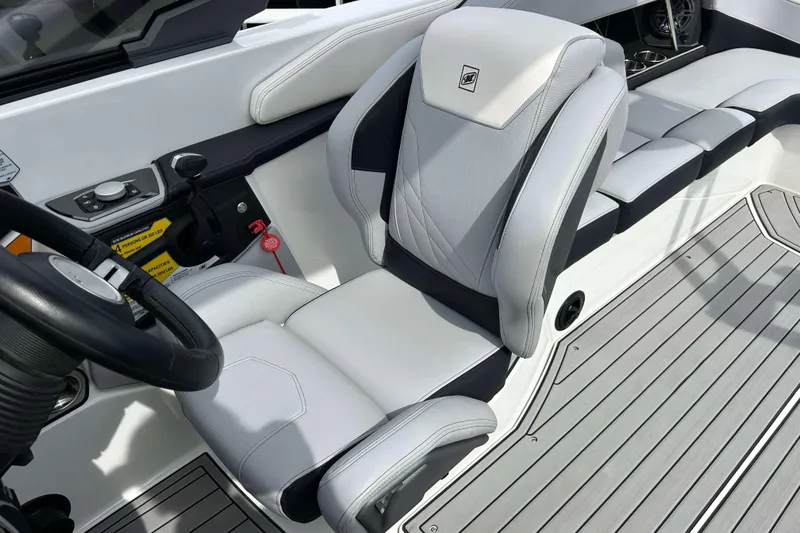 Slide: The Image of 2021 Nautique Super Air Nautique GS24 interior with sleek, modern seating and controls. - 17