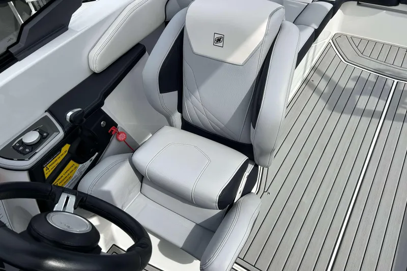 Slide: The Image of 2021 Nautique Super Air Nautique GS24 boat interior with sleek seating and modern controls. - 18
