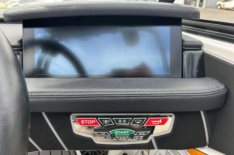 Slide: The Image of 2021 Nautique Super Air Nautique GS24 dashboard with touchscreen and control buttons. - 21