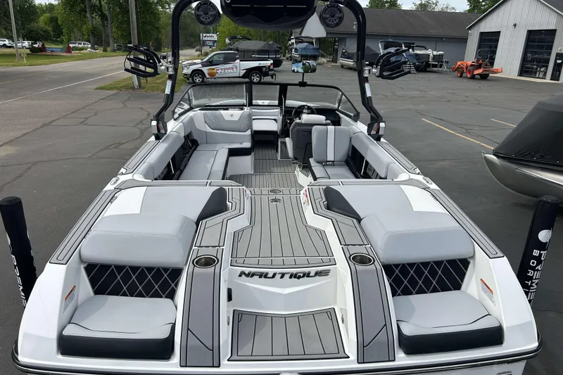 Slide: The Image of 2021 Nautique Super Air Nautique GS24 boat with spacious seating and sleek design. - 3