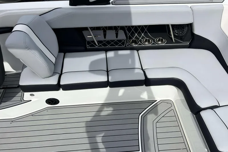 Slide: The Image of 2021 Nautique Super Air Nautique GS24 interior seating with sleek design and cup holders. - 11