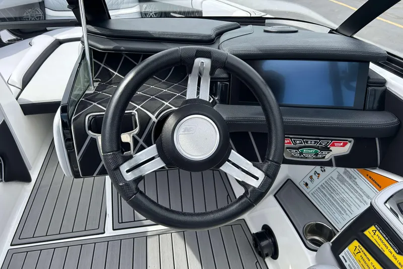 Slide: The Image of 2021 Nautique Super Air Nautique GS24 dashboard with steering wheel and touchscreen display. - 20