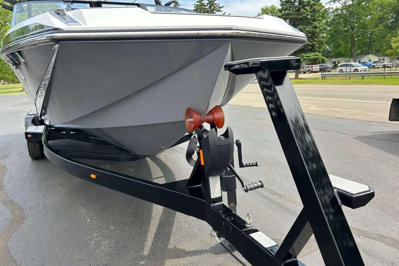 Slide: The Image of 2021 Nautique Super Air Nautique GS24 boat on trailer, parked outdoors. - 32