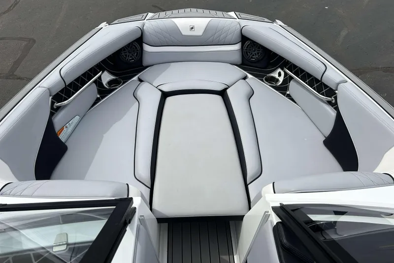 Slide: The Image of 2021 Nautique Super Air Nautique GS24 boat interior with luxurious seating and cup holders. - 25