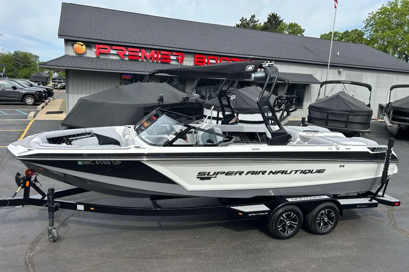 The Image of 2021 Nautique Super Air Nautique GS24 boat on trailer at dealership. - 1