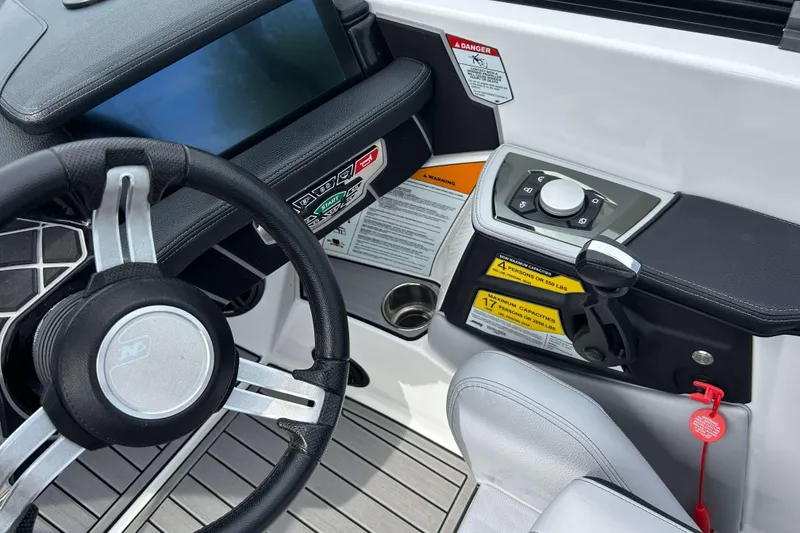 Slide: The Image of 2021 Nautique Super Air Nautique GS24 dashboard with steering wheel and control panel. - 19