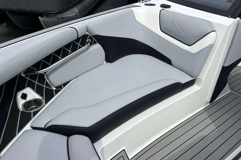 Slide: The Image of 2021 Nautique Super Air Nautique GS24 interior seating with sleek, modern design and cup holder. - 28