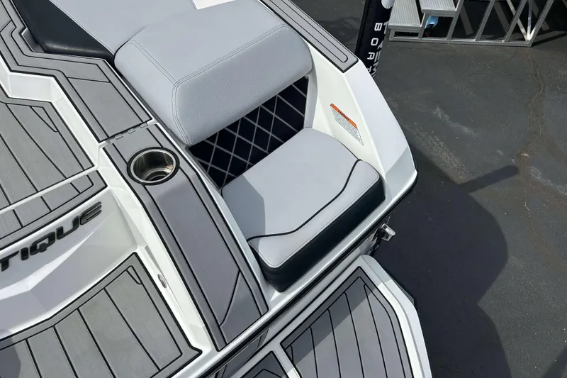 Slide: The Image of 2021 Nautique Super Air Nautique GS24 boat interior with gray seating and cup holder. - 4