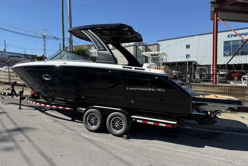 Slide: The Image of 2026 Chaparral SSX 30 boat on trailer, black exterior, parked outdoors. - 4