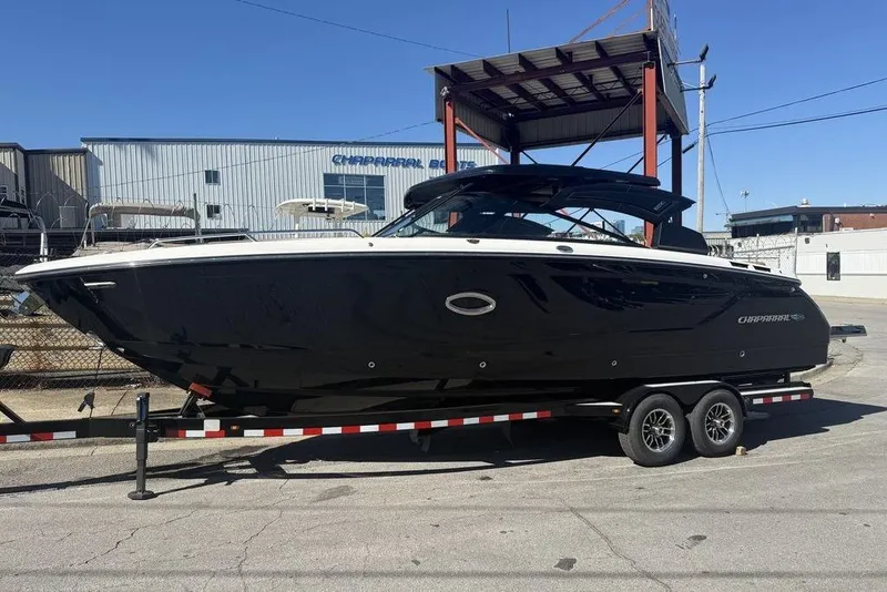 Slide: The Image of 2026 Chaparral SSX 30 boat on trailer, sleek black design, outdoor setting. - 3