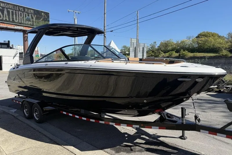 Slide: The Image of 2026 Chaparral SSX 30 boat on trailer, sleek black design, parked outdoors. - 2