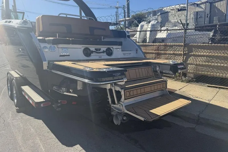 Slide: The Image of 2026 Chaparral SSX 30 boat on trailer, featuring a spacious swim platform and seating area. - 7