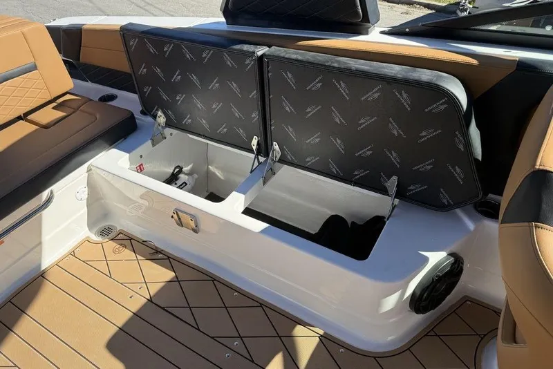 Slide: The Image of 2026 Chaparral SSX 30 boat interior with open storage compartments and cushioned seating. - 12