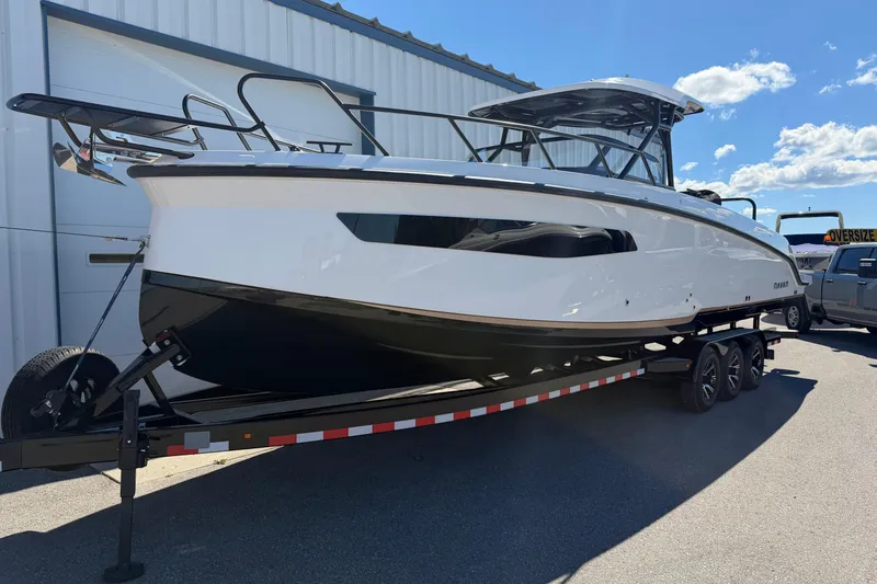 The Image of 2026 Navan S30 boat on trailer, parked outdoors under clear blue sky. - 2