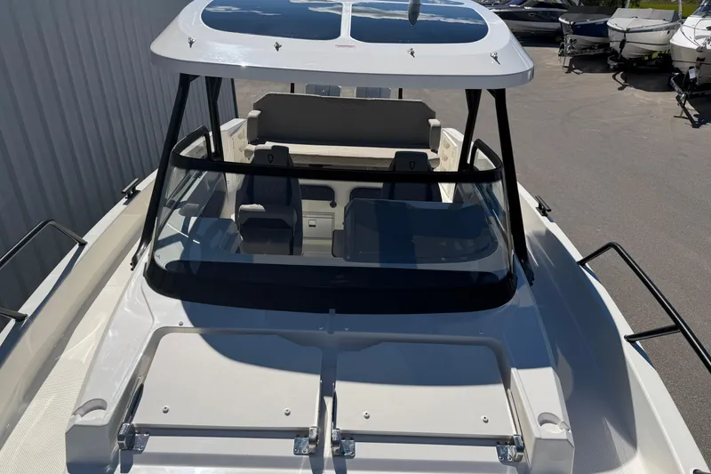Slide: The Image of 2026 Navan S30 boat with sleek design and spacious cockpit, docked outdoors. - 27
